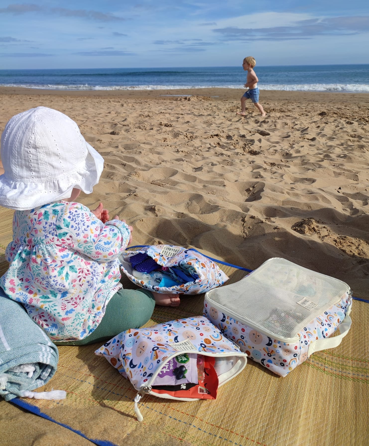 girl using packing cubes on the beach